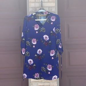 Medium blue dress with purple flowers, neck strap.